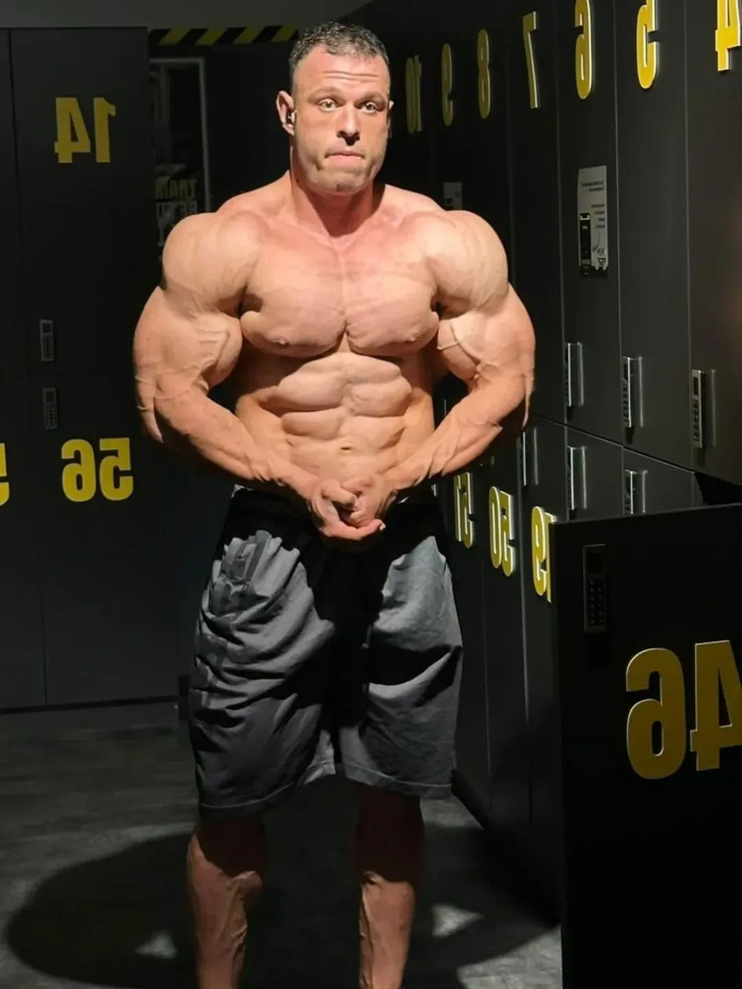 Bozhidar Pecakovski hitting a most muscular pose in a gym locker room during offseason
