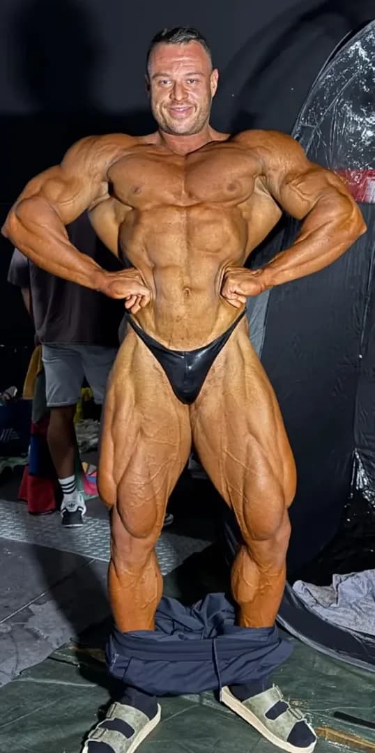 Bozhidar Pecakovski front lat spread backstage in 2025, visibly fuller and more conditioned